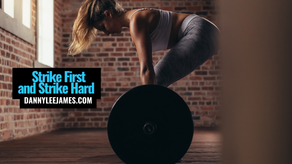 Fit woman deadlifting in gym