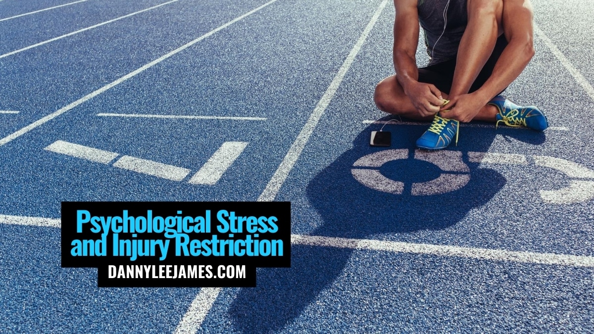 Male athlete sitting on blue track under psychological stress
