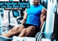 Fit man in blue performing leg extension machine for fat spot reduction